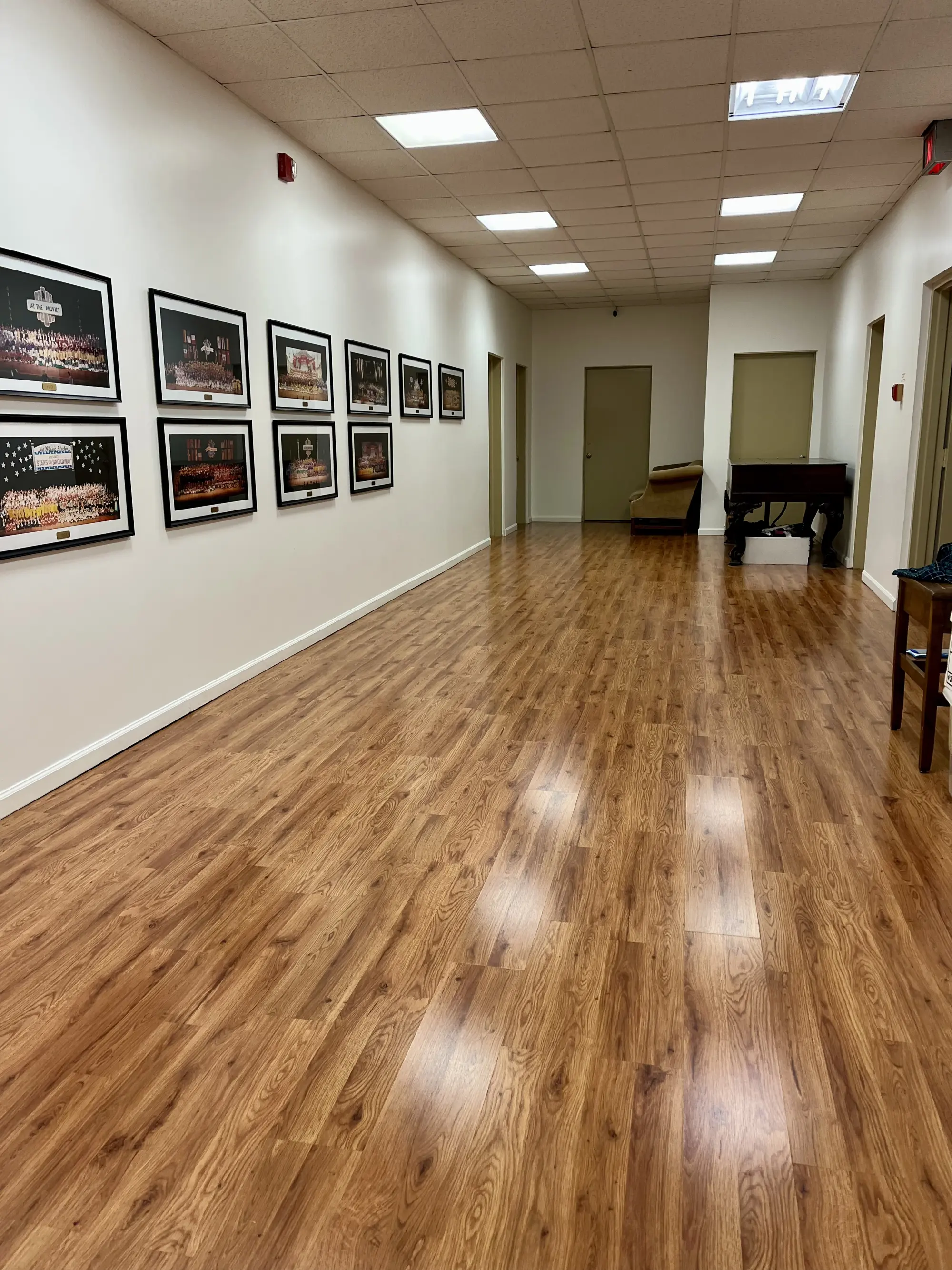 Long laminate-floor hallway cleaned to a clean shine in a Capital District commercial space.