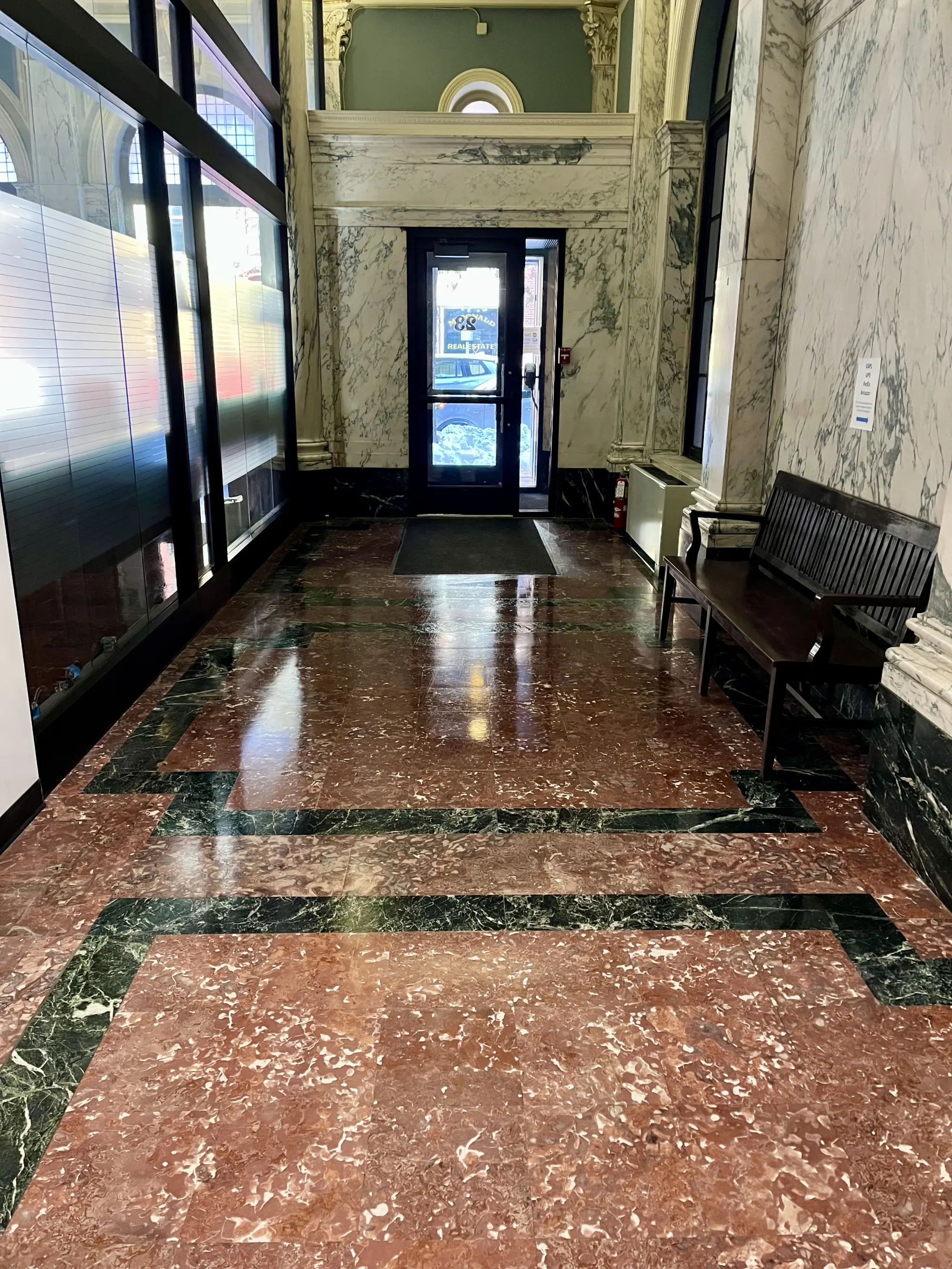 Polished patterned marble entryway in a historic Capital District commercial building.